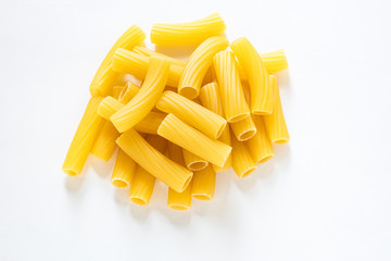 traditional italian pasta isolated on white background, heap of tortiglioni pasta, durum wheat noodles