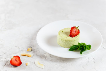 Homemade avocado panna cotta with strawberries and mint. Sugar, lactose, gluten free. Healthy food, diet, vegetarian.