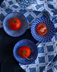 Still life with tomatoes and blue bowls on diaper