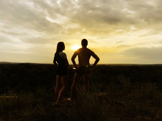 Fototapeta na wymiar silhouette of a couple on a sunset background