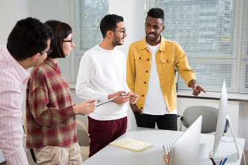 Multy-ethnic group of creative business people working with computer at office