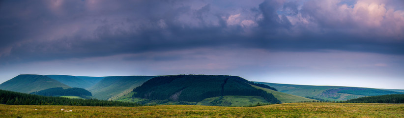 The colors of the sunrise. Panorama of Brecon Beacons National Park in Wales.