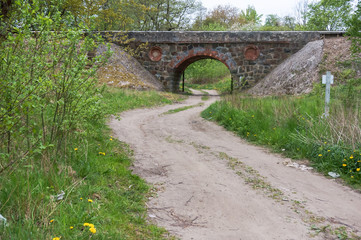 Bridge overpass made of stone. Stone arch over the road.