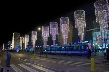 Krakow, Poland: Wide angle view of decorated shopping mall during Christmas holidays and a public tram in motion blurred