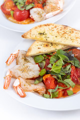 garlic butterfly prawn with roasted tomatoes dish