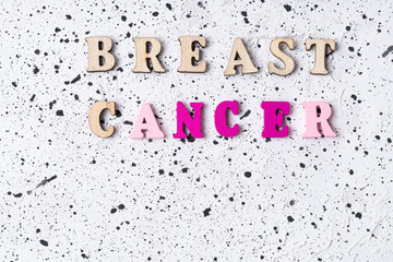 Fototapeta premium Breast Cancer word on white cement background.Breast cancer.