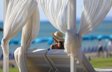 blonde girl sitting in the gazebo