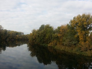 Beautiful autumn landscape forest and river with water reflection day light  Sumy region Ukraine
