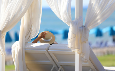 blonde girl sitting in the gazebo