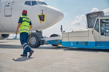 Man in uniform heading towards an airliner