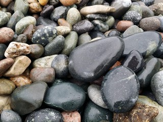 wet sea stones small  rocks natural background  seascape vacation concept wallpaper texture close up selective focus