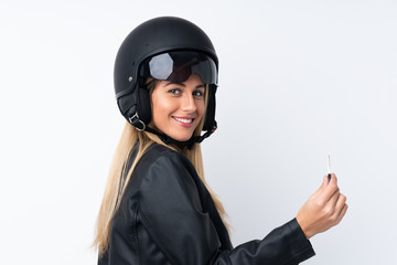 Young Uruguayan woman with a motorcycle helmet over isolated white background