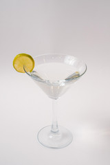 Glass of vermouth decorated with a lime slice.