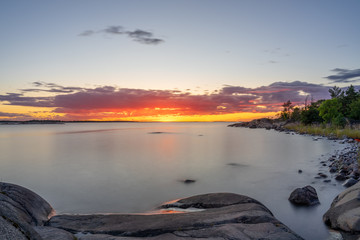 Long exposure of a summer sunset with silky smooth water.