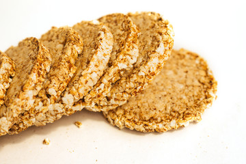 Crunchy and airy loaves on a white background, diet crunchy round rice waffles.