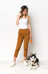 A full length young pretty woman with her dog