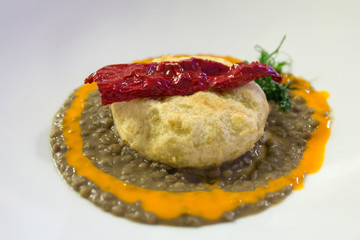 Fried Codfish with red pepper, pumpkin cream and lentils, typical italy plate in a Christmas Holiday