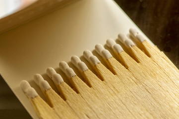 macro shoot of advertising wooden matches with a head of white phosphorus in the matchbook. natural light