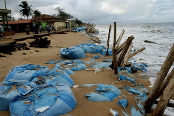 mucuri, bahia / brazil - august 25, 2009: containment made of a sandbag to prevent the sea from...