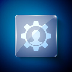 White Human with gear icon isolated on blue background. Artificial intelligence. Thinking brain sign. Symbol work of brain. Square glass panels. Vector.