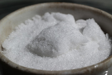 Snow-white crystals of potassium nitrate in a crucible, the substance is used in technical pyrotechnics as a strong oxidizing agent, and in the agriculture as nitrogen fertilizer.