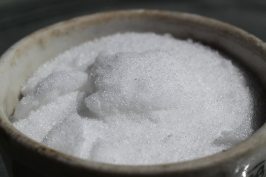 Crystalline inorganic white matter, mineral fertilizer, potassium nitrate in crucible.