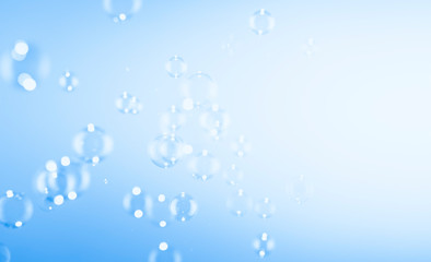 Bubbles abstract background. Transparent clear blue soap bubbles float in the air with copy space.