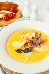 Creamy soup with seafood. Octopus and mussels. Beautiful food, serving. Light photo. Mediterranean Kitchen