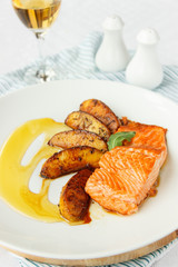 Salmon fillet with fried potatoes. Honey sauce. Beautiful presentation and serving. Mediterranean Kitchen. Light photo.