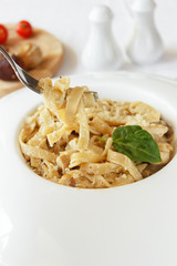 
Paste. Noodles with mushrooms and creamy sauce. Close-up. Italian and Mediterranean cuisine
