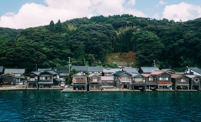 Fototapeta na wymiar “Ine no Funaya (伊根の舟屋)” is a small village located in Ine town, Kyoto prefecture. Ine is a small town in northern Kyoto, approx 130km away from Kyoto city. The village stretches approx 5km along Ine B