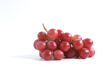 Red grapes on the vine on a white background