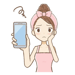 ルームウエアを着た女性がスマホを見て悩んでいる　上半身
