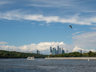 Fototapeta na wymiar Tourist ship floating on the river. View of the Moscow river and Sparrow hills.