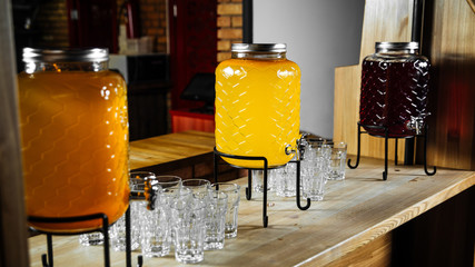 Buffet variety of lemonade jars with glasses 