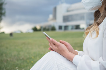 Girl and cell phone close-up shot on a summer day