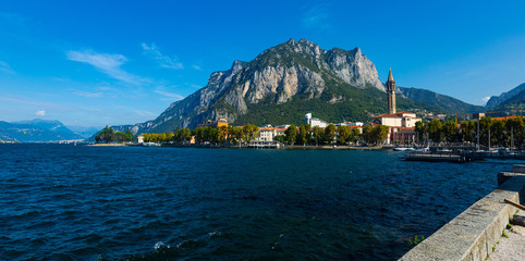 Spectacular view of Italian city of Lecco at foot of San Martino mountain on shore of Lake Como overlooking gothic bell-tower of Minor Basilica of San Nicolo, Lombardy..