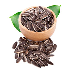 sunflower seeds in wooden cup isolated on white background