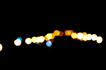 Bokeh light of street lamps at night with blurred background.