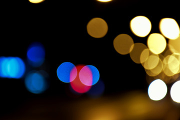 Bokeh light of street lamps at night with blurred background.