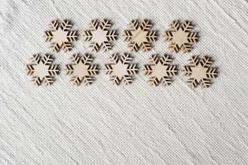 Christmas background linen canvas textile with wooden snowflakes