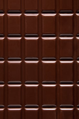 Pure chocolate bars, looking especially delicious. they are squared blocks shaped