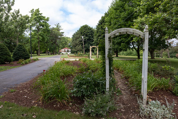 Fototapeta na wymiar Arched Trellises and Plants in a Beautiful Garden at Dellwood Park in Lockport Illinois during the Summer