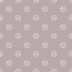 Abstract white dotted circles creating texture effect. Seamless vector pattern on dusty pink background . Backdrop with irregular hand drawn spheres. All over print for wellbeing, spa packaging.