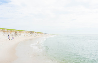 Scenic ocean background with people walking in the distance