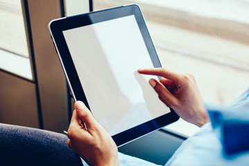 Cropped image of female user with portable PC for online messaging during wireless networking on website, woman watching influence streams while browsing web information and installing application