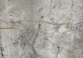 Wall background made of cracks. The texture of gray, dirty, cracked concrete.