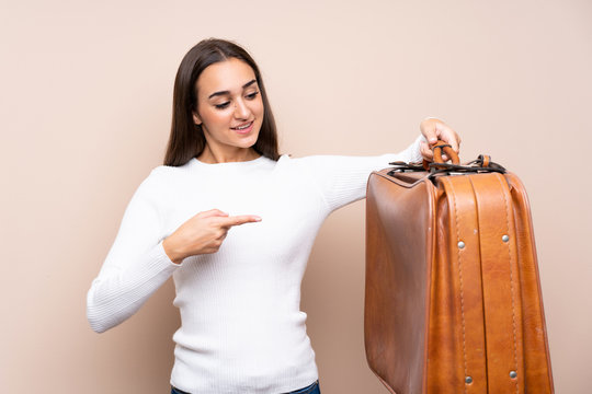 Young Woman Over Isolated Background Holding A Vintage Briefcase