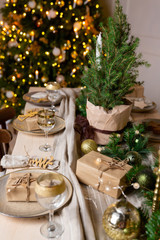 Christmas or New Year decoration of the festive table. Table setting with dishes. Spruce tree decoration.