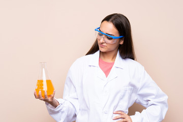 Young woman over isolated background with a scientific test tube